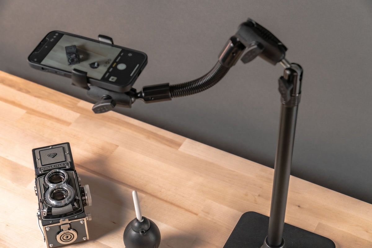 iBOLT studio photograph of a phone camera framing a staged tabletop subject