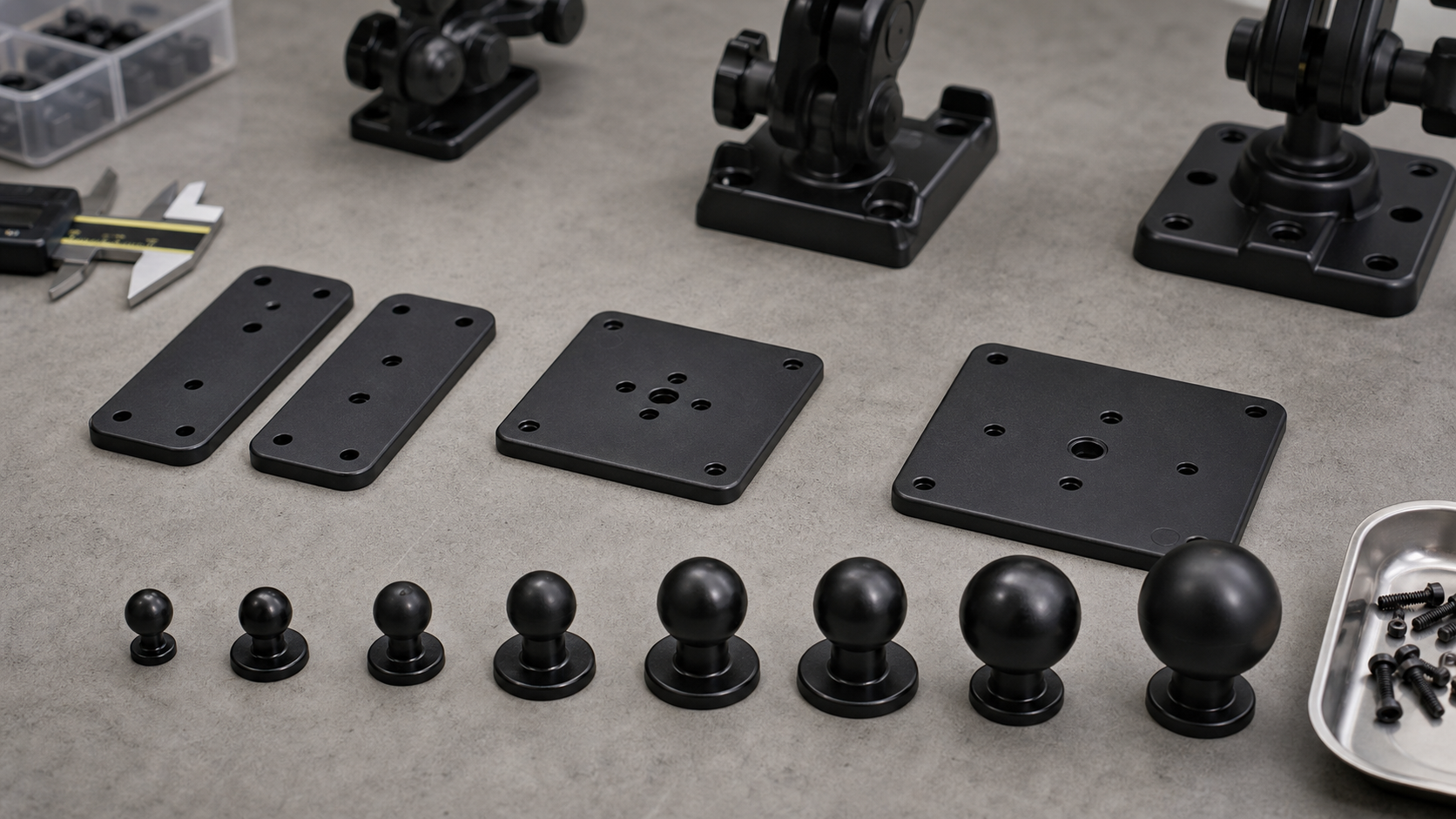 AMPS plates VESA plates and ball mount sizes arranged on a workbench